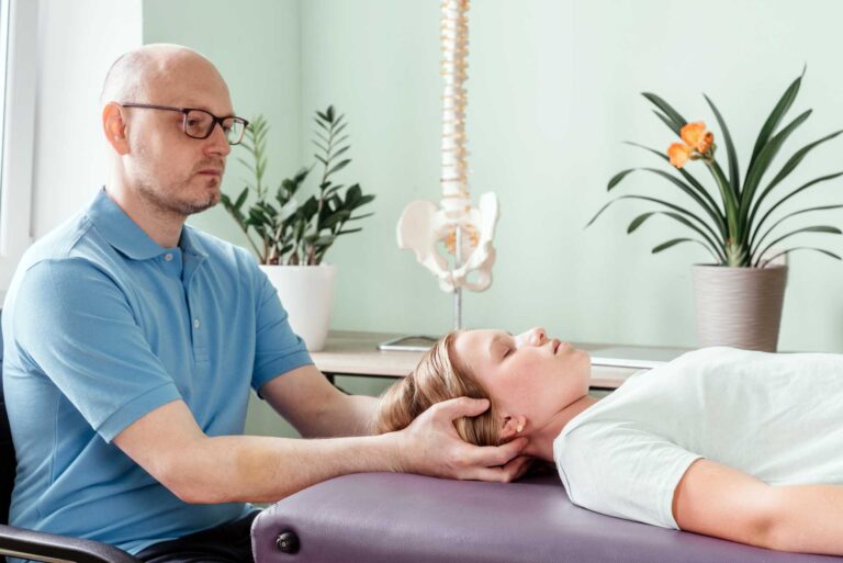 A therapist using osteopathic techniques to treat a girl.