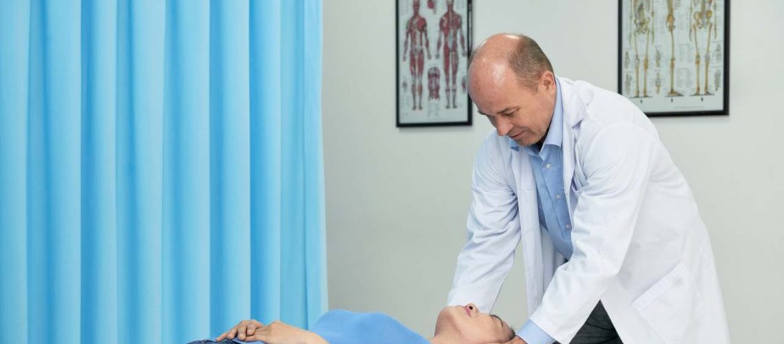 osteopathy benefits, a male practitioner massaging a patient's neck